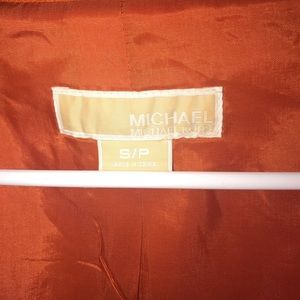 Orange Michael Kors jacket with belt